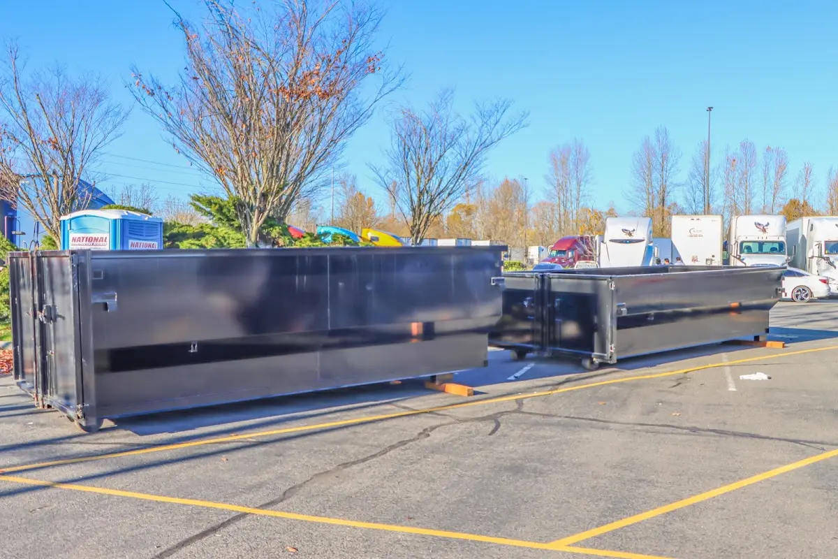 Professional dumpster rental service with roll-off container on residential driveway in Bartow